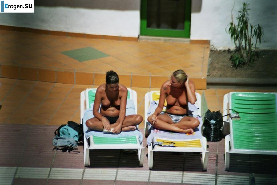 Girls sunbathe topless near the pool. Part 2. Photo 18