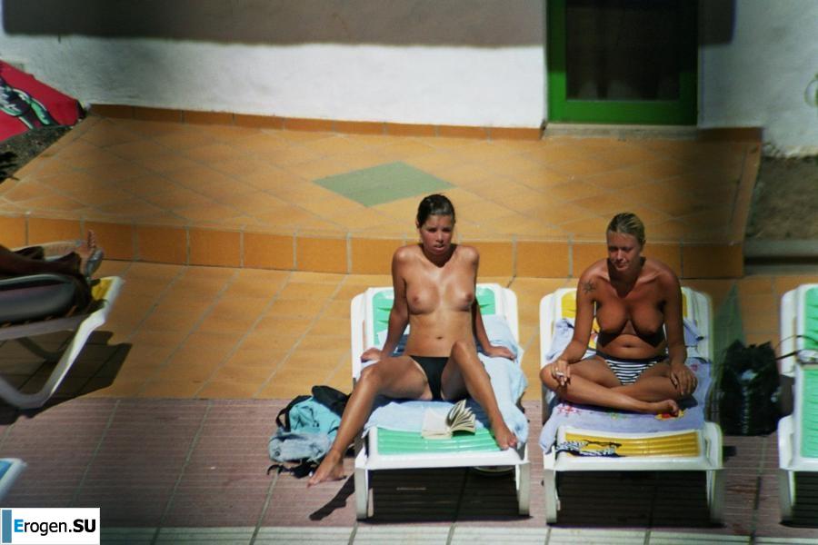 Girls sunbathe topless near the pool. Part 2. Photo 19
