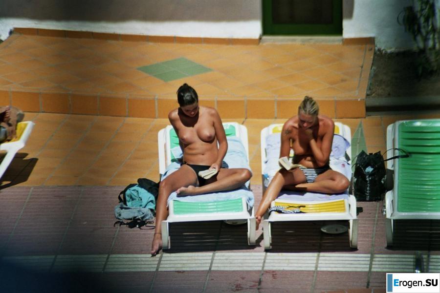 Girls sunbathe topless near the pool. Part 2. Photo 7