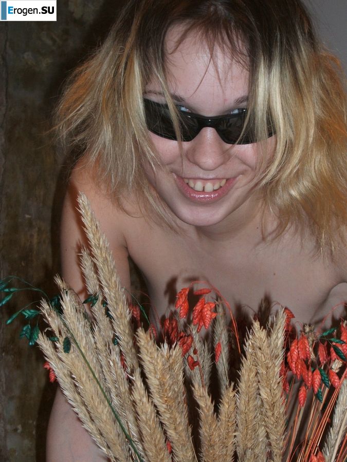 A blonde with a thin waist poses in glasses and red panties. Part 2. Photo 12