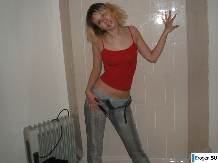 A blonde with a thin waist poses in glasses and red panties. Part 2. Photo 6