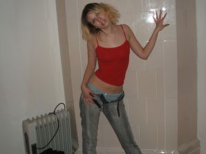 A blonde with a thin waist poses in glasses and red panties. Part 2. Thumb 6