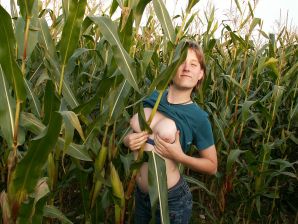 A thin student pleases herself with corn right in the field. Thumb 5