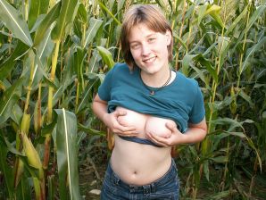 A thin student pleases herself with corn right in the field. Thumb 8